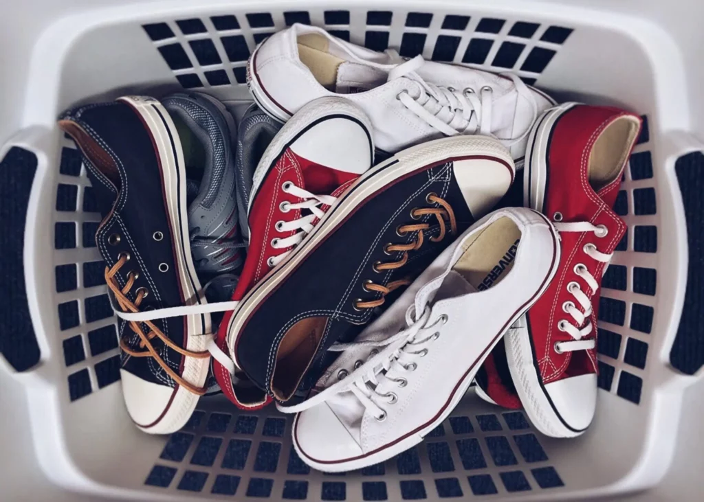 A laundry basket filled with shoes