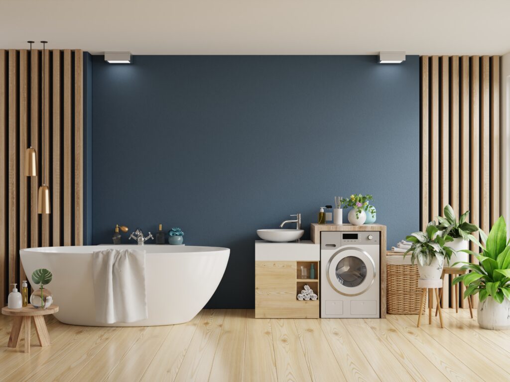 Bathroom interior with white bathtub on dark blue wall