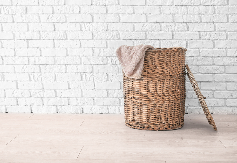 laundry basket in front of a brick wall